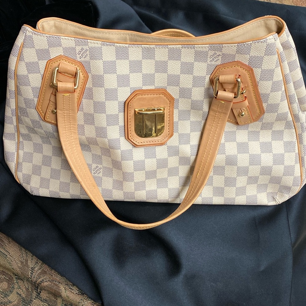 This is an authentic LV Azure bag. Please look at the pictures for damages.
